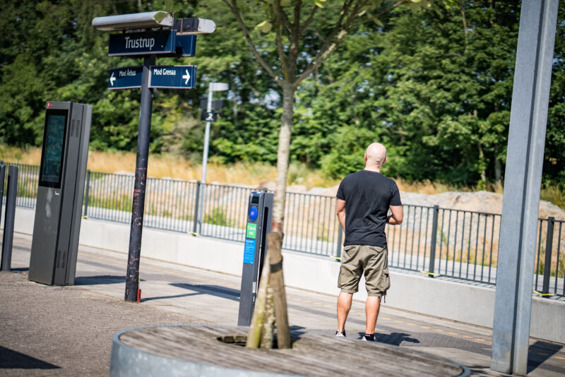 Trustrup Station med holdende letbanetog og menneskemylder